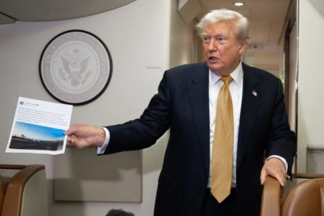 President Donald Trump holds up a copy of his Truth Social post about Air Force One as he speaks with the media aboard Air Force One on July 8, 2026. The president's media company is offering investors early access to his Truth Social feed for up to $100,000 a month, raising ethical and legal concerns. Saul Loeb/AFP via Getty Images