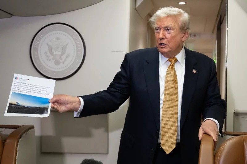 President Donald Trump holds up a copy of his Truth Social post about Air Force One as he speaks with the media aboard Air Force One on July 8, 2026. The president's media company is offering investors early access to his Truth Social feed for up to $100,000 a month, raising ethical and legal concerns. Saul Loeb/AFP via Getty Images