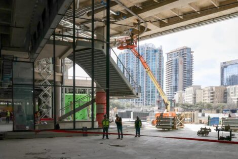 Construction workers stand at the site of Goldman Sachs' new campus in Dallas on March 3, 2026. The New York investment bank is supersizing its presence in the Texas city amid a financial boom. Local political leaders and the banking executives they've wooed are calling it "Y'all Street." Yfat Yossifor/for NPR