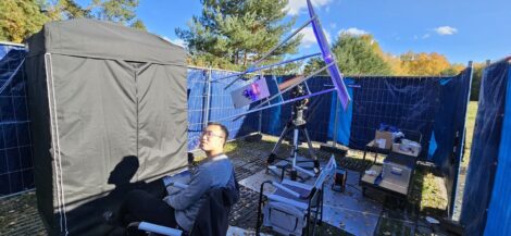 Cheng Li is shown with the outdoor experimental setup. The sunlight concentration module, including the Fresnel lens and the solar concentrator, is mounted on a solar-tracking motor to ensure stable power delivery. The entanglement generation and detection setup, including the nonlinear crystal and the single-photon detectors, are shielded in an optical enclosure placed inside a blackout tent. Credit: Jasvinder Brar, Max Planck Institute for the Science of Light