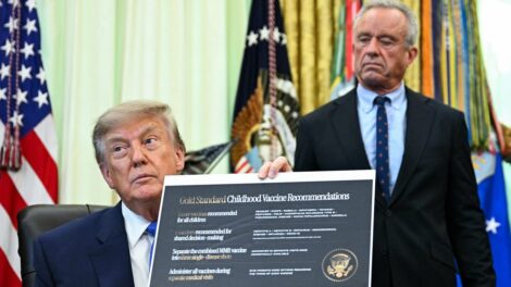 Image: Trump signs executive order on childhood vaccines, claiming discredited link between vaccines and autism