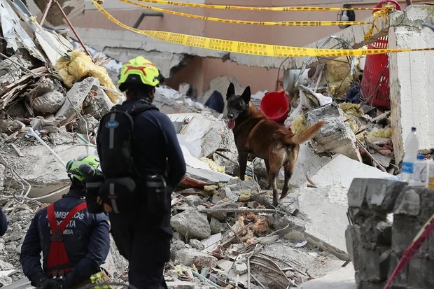 Firefighters search through rubble two days after an earthquake struck Cali, Colombia, on Aug. 12, 2026. AP/Santiago Saldarriaga
