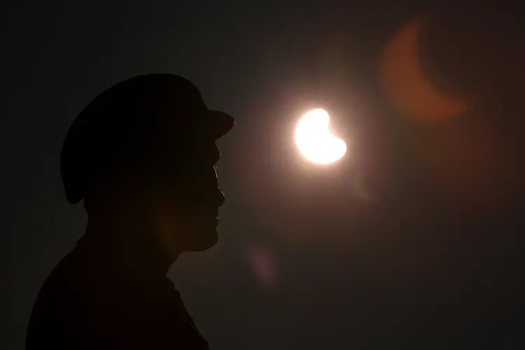 A partial solar eclipse is seen over the Miner's Family Statue in Tonypandy, Wales, on March 20, 2015.Nathan Stirk - Getty ImagesChristopher Furlong—Getty Images