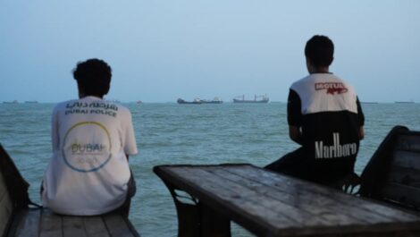 BANDAR ABBAS, IRAN - AUGUST 10: Two youths sit on the shoreline as ships are seen anchored in the Strait of Hormuz on August 10, 2026 off the coast of Bandar Abbas, Iran. (Photo by Ali Saeedi/Getty Images) Getty Images | Getty Images News | Getty Images