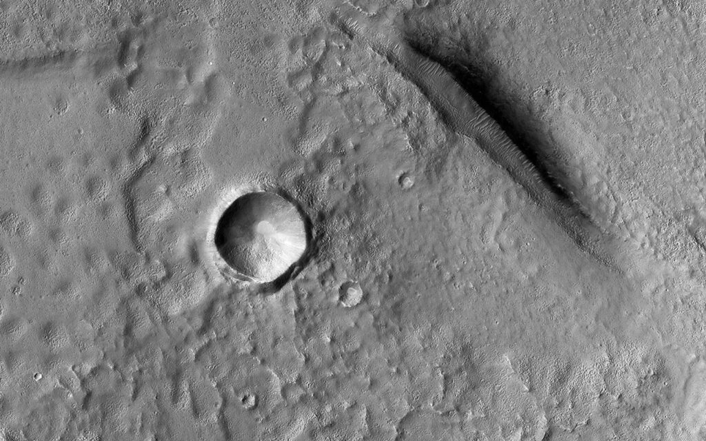 NASA Mars Reconnaissance Orbiter view of bumpy and pitted terrain elsewhere in Utopia Planitia. Regional context image, not the Zhurong gypsum outcrop. Credit: NASA/JPL-Caltech/University of Arizona. Public domain. Source.