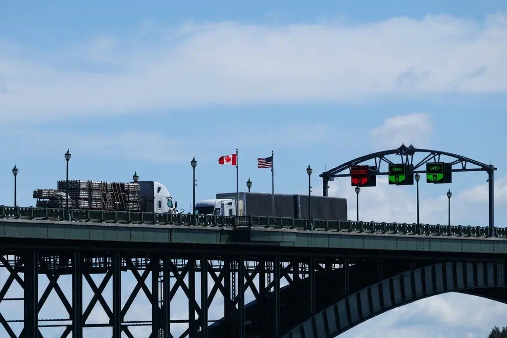 Trucks passing over the Peace Bridge between Canada and the United States on Tuesday.Credit...Cole Burston/Agence France-Presse — Getty Images